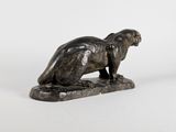 an image of a statue of a cat sitting on a rock