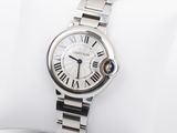 a close up of a wrist watch on a white pillow
