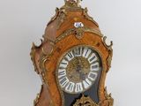 a clock that is sitting on a table with a key
