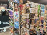 a display of greetings in a store with a man standing next to it