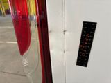 a sticker on the side of a refrigerator with a ruler attached to it