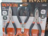 three pairs of pliers in a box on a table
