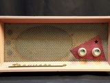 a close up of an old fashioned radio with two eyes on it