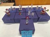many glass figurines of santa claus on display
