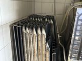 un radiateur dans un coin d'une pièce, sur lequel est posé un téléviseur