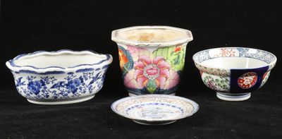 several different types of vases and bowls on a black background
