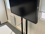 a flat screen tv sitting on a stand in a room