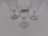 three wine glasses with numbers on them sitting on a white surface