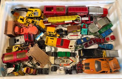 a box full of toy cars and trucks in it