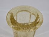 a glass vase with a gold rim sitting on a white surface