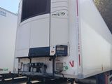 a white truck that is parked next to other trucks