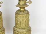 two golden candles that are sitting on top of each other