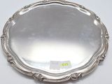 a silver plate with a decorative design on the rim