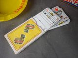 four playing cards sitting on a table next to a yellow plate