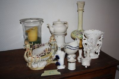 many different vases on a table with a candle on it