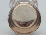 an image of a silver cup on a white surface