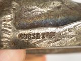 a close up of a silver statue of a dog