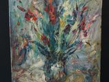 a painting of flowers in a vase on an easel