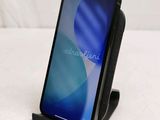 a phone that is sitting on a stand on a table