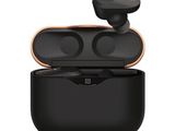 a pair of black and gold earphones sitting on top of each other
