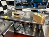 stainless steel counter top in a commercial kitchen with a box of food on the counter