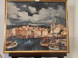 un tableau posé sur un chevalet, avec une vue de ville en arrière-plan
