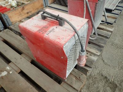 a red machine that is sitting on a pallet