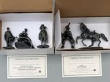 three figurines of men riding horses in a box