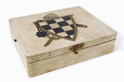 a small wooden box with a crest on it