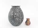 two vases sitting next to each other on a white surface