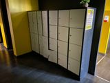 a bunch of lockers in a hallway with a plant on top of them
