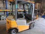 a forklift truck that is parked in a warehouse