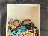 a small box with a bunch of jewelry inside of it
