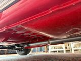 a red car that is parked in a garage