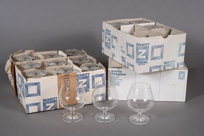 several empty wine glasses are sitting next to a box of empty wine glasses