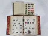 an open book with stamps on it sitting on a white surface