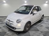 a picture of a small white car parked in a garage