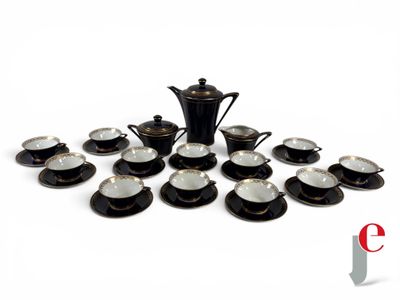 a picture of a black and white tea set with cups and saucers
