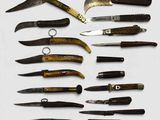 many different types of knives on display on a table