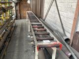 a long conveyor belt in the middle of a warehouse