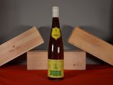 a bottle of wine sitting on a table next to a box