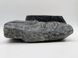 sculpture of a rock on a white surface with a white background