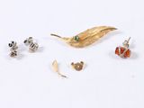 a small collection of jewelry on a white surface