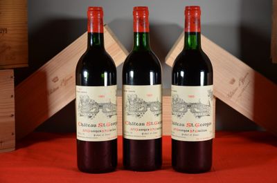 three bottles of red wine sitting next to each other on a table