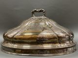 an antique silverplated covered dish with a horse head on top