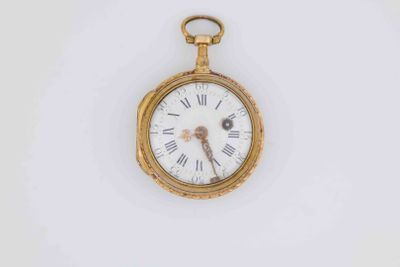 a gold pocket watch with roman numerals on the face