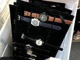 a plastic container with a bunch of watches inside of it