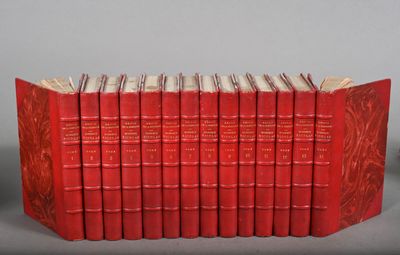 a group of red books sitting on top of each other on a table