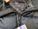 a jacket that has a tag on it and a tag attached to it