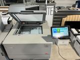 a photo of a printer and a tablet on a desk